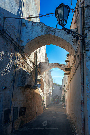 Narrow Alley Amidst Buildings In Ostuni, Italy