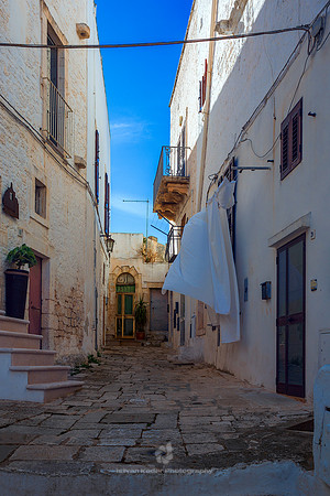 Narrow Alley Amidst Buildings In Ostuni, Italy