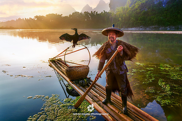 Cormorant Fisherman Poles a Bamboo Raft on Li River, Xingping
